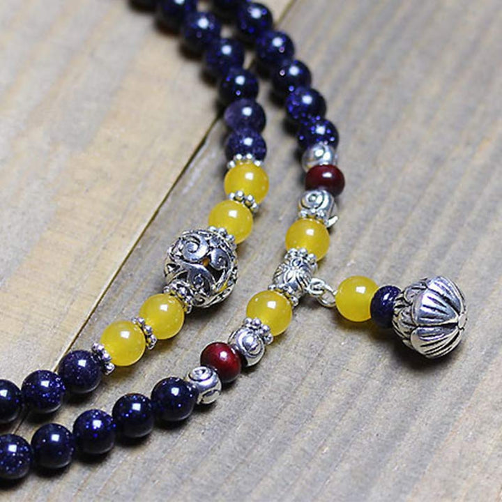 Mala – Wohlstand Armband mit dunkelblauem Lapislazuli und gelbem Citrin Stein.
