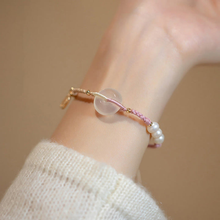 Armband – Frieden mit Rosenquarz, Perlen und lila Kristallen elegant.