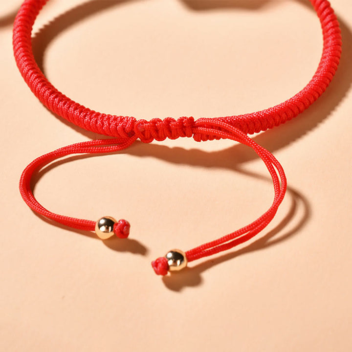 Rotes Seidenschnur Armband mit goldenen Perlen Verschluss elastisch