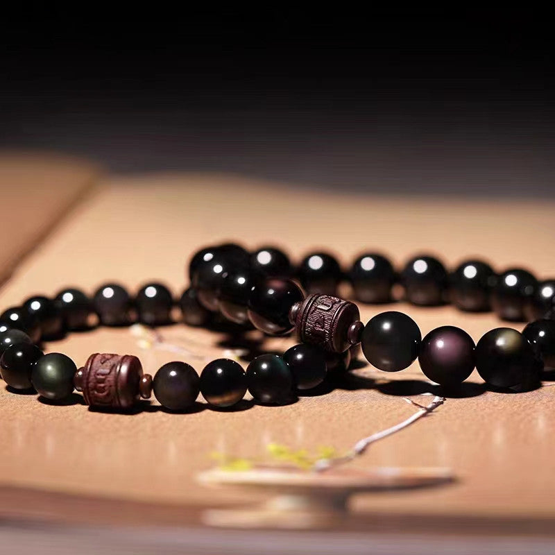 Schwarzes Obsidian Armband mit Om Symbol Perlen elegant arrangiert