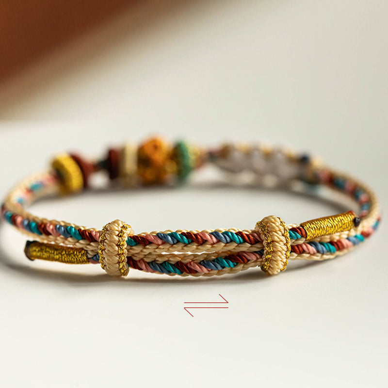 Armband Pfirsichblüte mit goldenen Perlen buntem Seil elegant.
