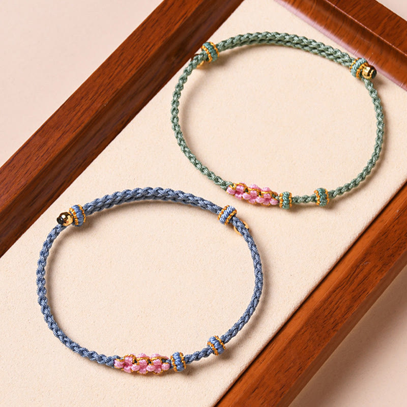 Zwei geflochtene Armbänder mit Perlen und Metallakzenten, Armband Pfirsichblüte – Schutz.