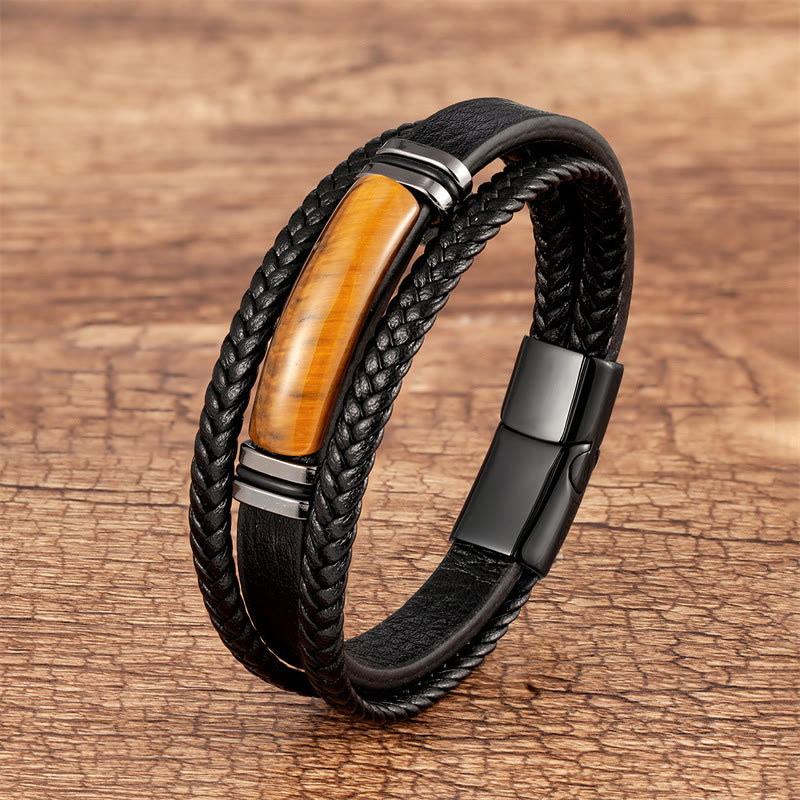 Schwarzes Leder Armband mit gelbem Tigerauge Stein auf Holz