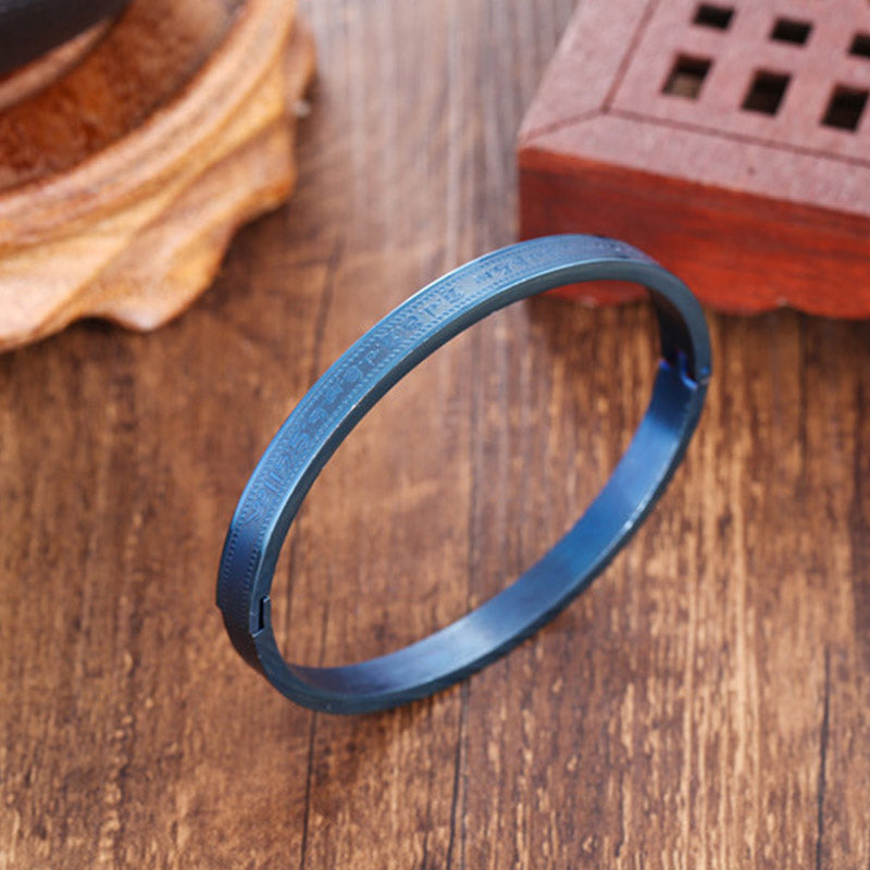 Blaues Titanstahl Armband Segen Armreif auf Holzoberfläche elegant.