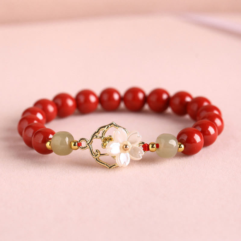 Armband Zinnober Jade – Segen rote Perlen goldene Blütenspange elastisch