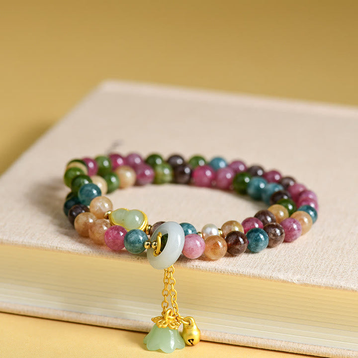 Buntes Turmalin-Kürbis-Armband mit goldenen Perlen und Anhänger.
