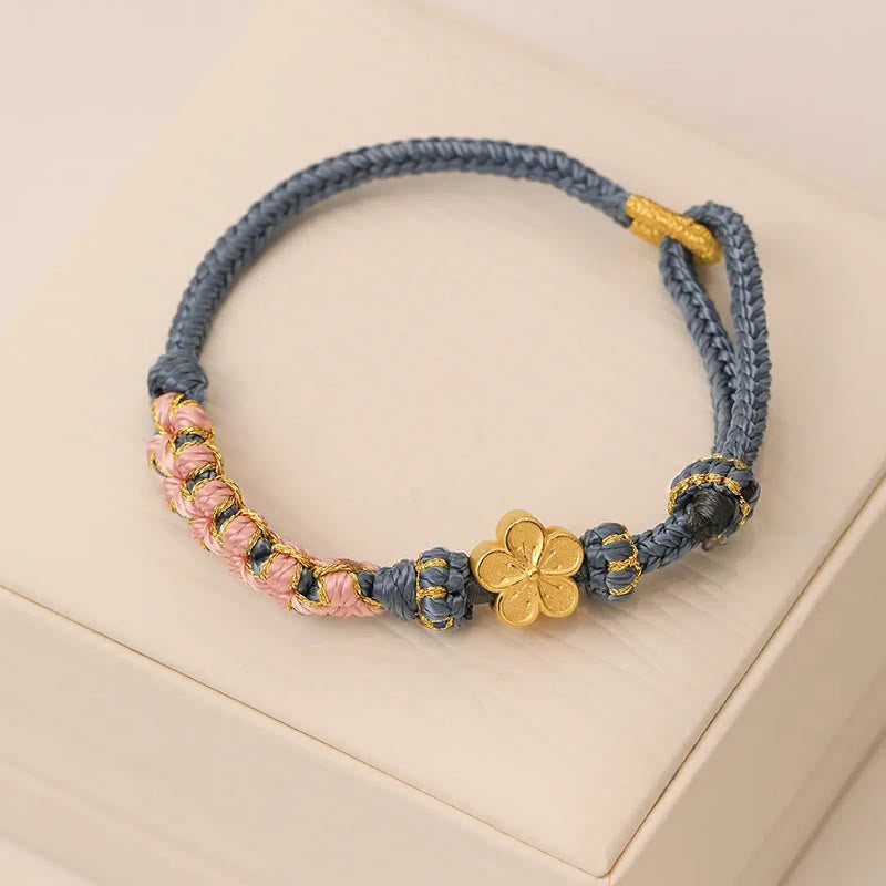 Armband Pfirsichblüte mit goldenem Blütenanhänger grauem Seil