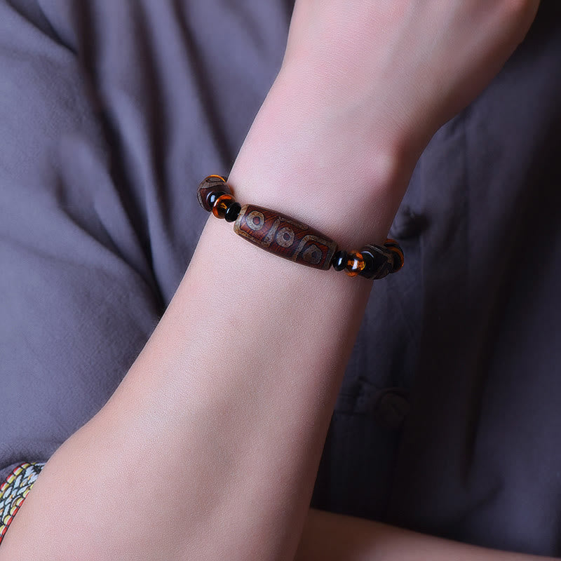 Armband Tibet Retro Neun-Eye Dzi Perle Segen braun elastisch getragen