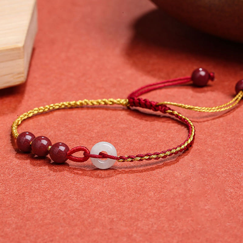 Armband Zinnober Jade – Frieden & Segen mit roten Perlen und weißer Jade.