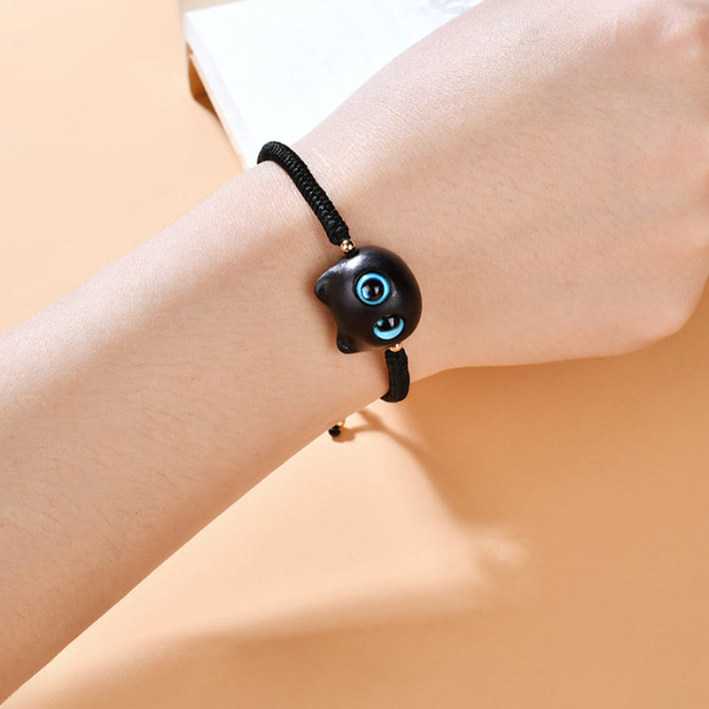 Armband Ebenholz Katze mit blauen Augen elegant am Handgelenk getragen