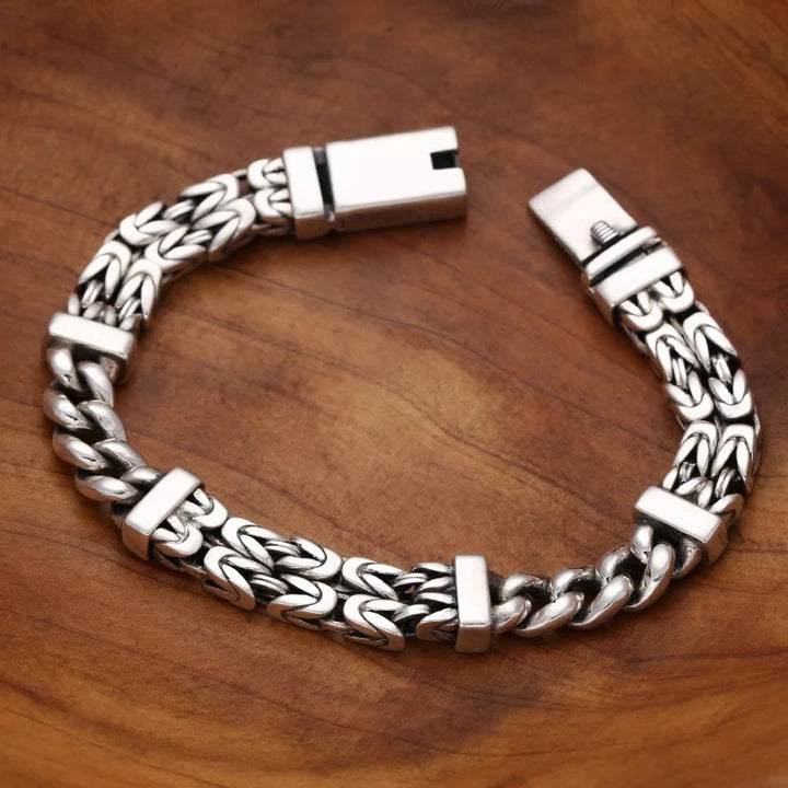 Silbernes Armband – Glück & Heilung mit Kettengliedern Holzhintergrund.