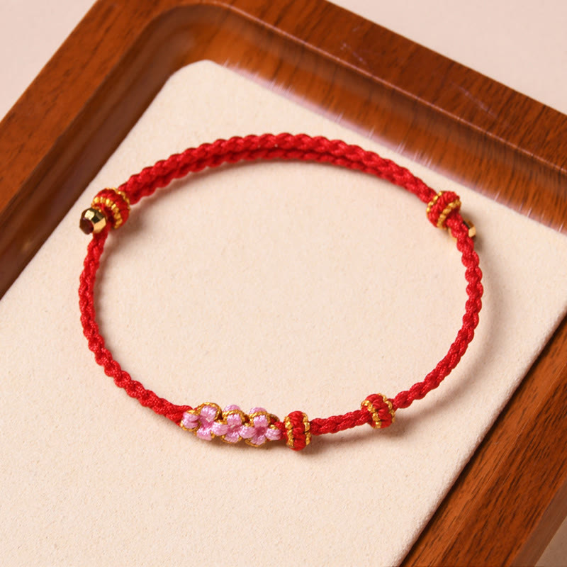 Rotes Armband Pfirsichblüte – Schutz mit rosa Perlen elastisch.
