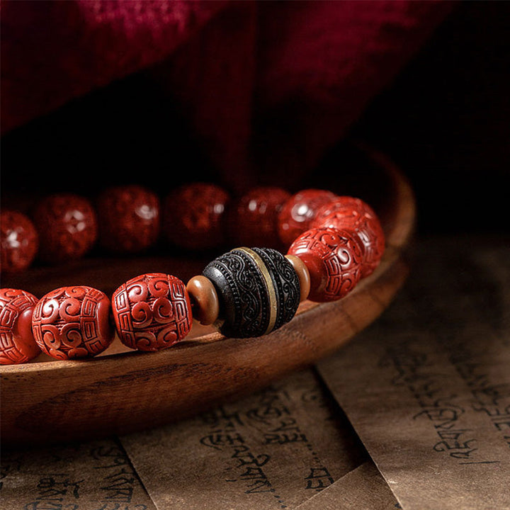 Armband Zinnober Ebenholz mit geschnitzten roten Perlen Segen Ruhe