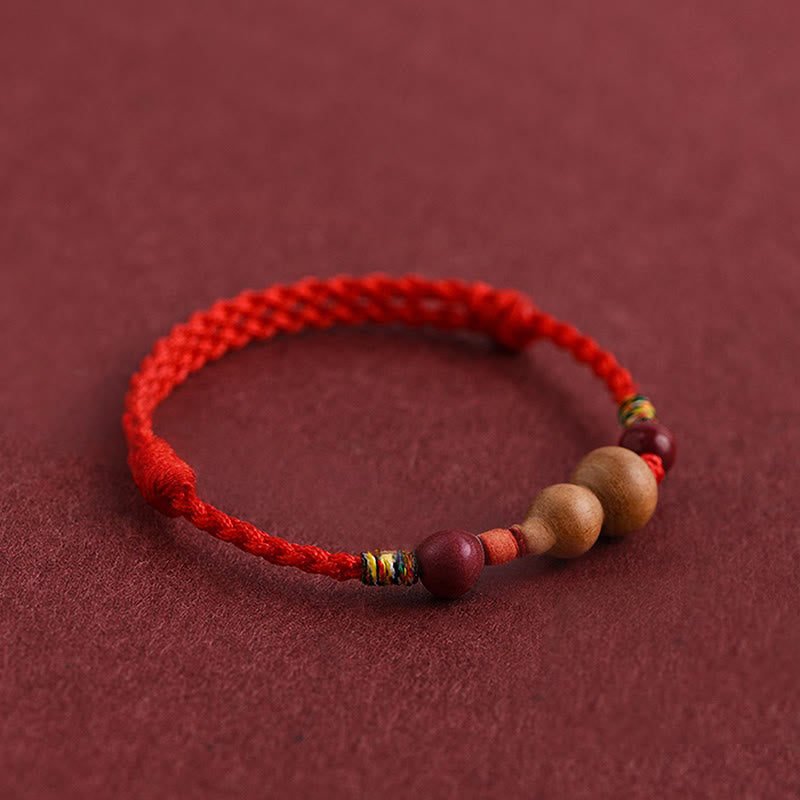 Armband Pfirsichholz Glück Wohlstand rotes geflochtenes Seil Holzperlen Schutz Handgelenk