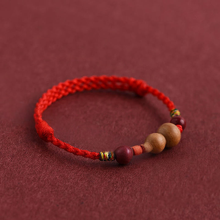 Armband Pfirsichholz Glück Wohlstand rotes geflochtenes Seil Holzperlen Schutz Handgelenk