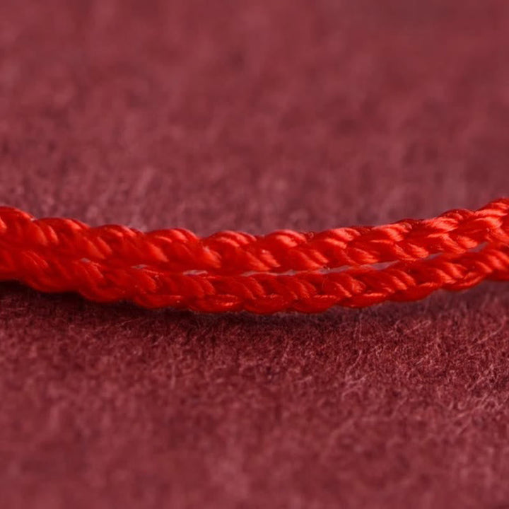 Armband 925 Silber Kürbis Glück rote Kordel geflochten Detail Nahaufnahme