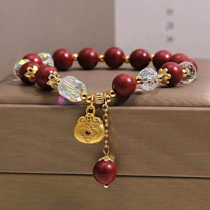 Armband Sandelholz Glück Heilung rote Perlen Kristall goldener Anhänger Handgelenk