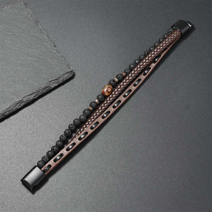 Armband Lavastein Wohlstand mit Leder Dzi-Perle auf Schieferplatte präsentiert