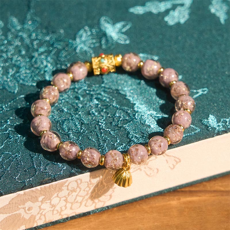 Armband Liuli Glück & Energie lila Perlen goldene Muschel Anhänger