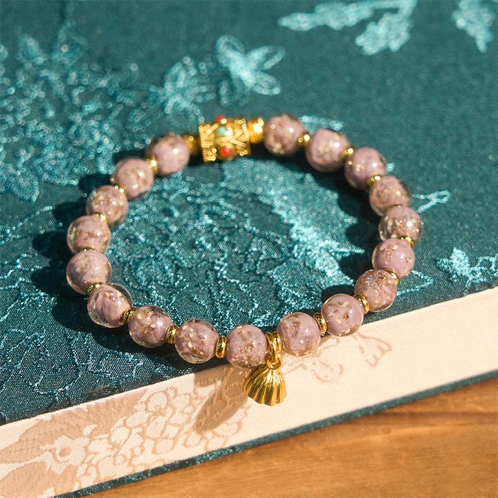 Armband Liuli Glück & Energie lila Perlen goldene Muschel Anhänger