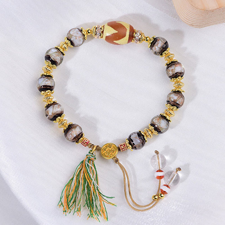 Armband Liuli – Segen mit Dzi Perle goldenen Details und Quaste