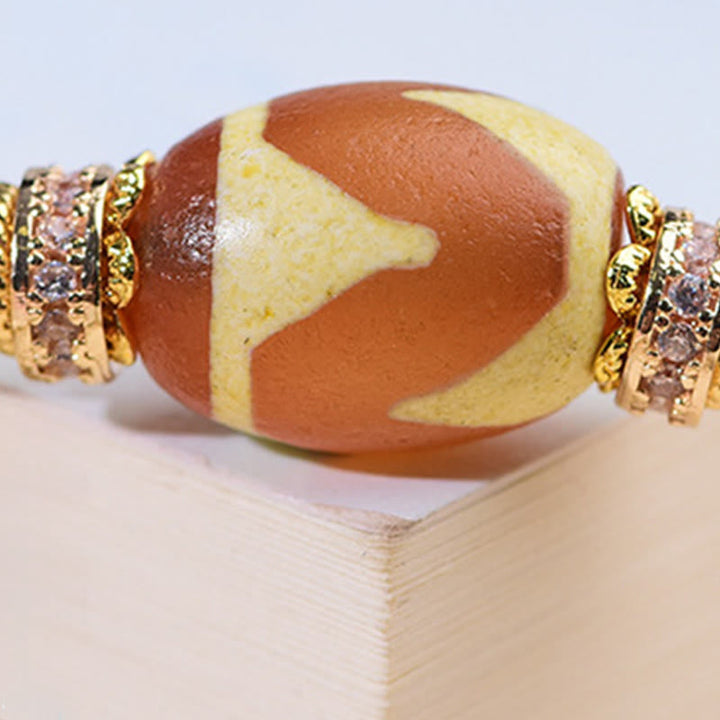 Armband Liuli – Segen mit orangener Perle und goldenen Kristallringen Handgelenk Schmuck