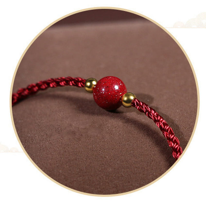 Armband Zinnober Rotes Band geflochten mit goldenen Perlen Glück Schutz