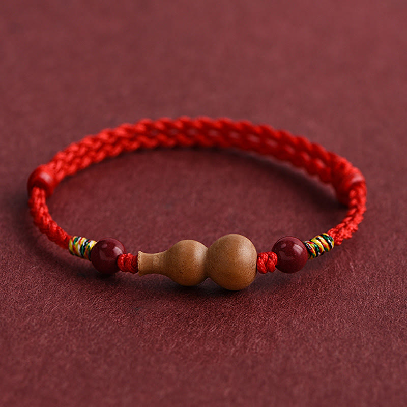 Armband Pfirsichholz Glück Wohlstand Kalebasse rote Kordel handgeflochten Schutz