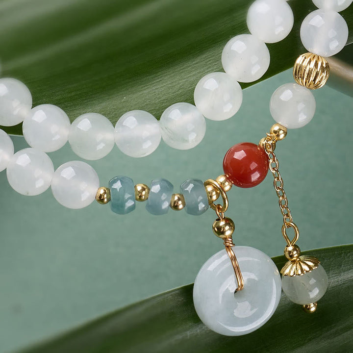 Armband Jade Achat Glück & Fülle weiße Perlen Anhänger auf Blatt