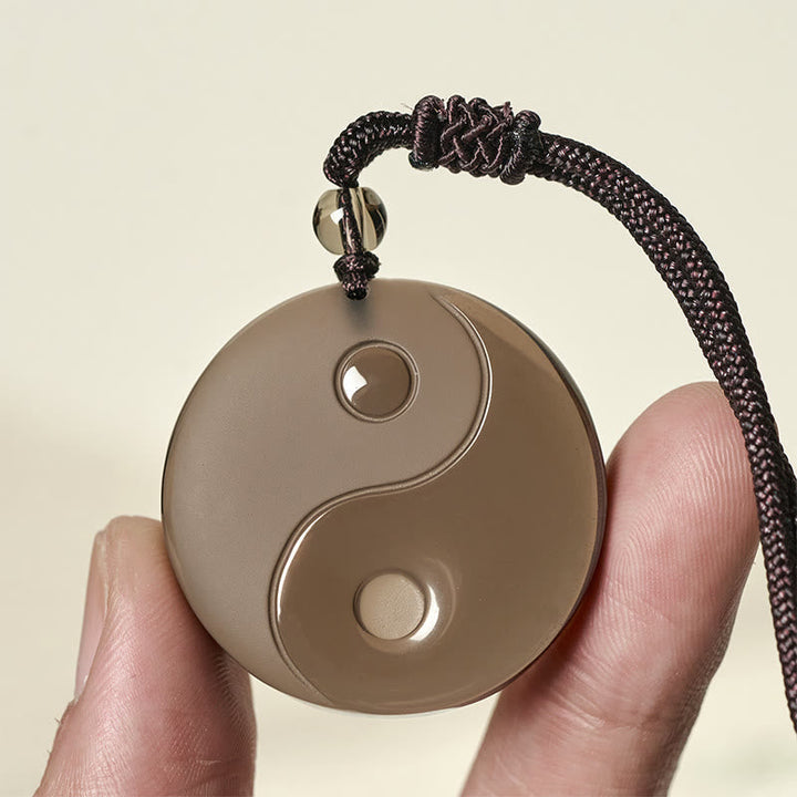 Yin Yang Anhänger Kette Obsidian braun Innere Stärke in Hand