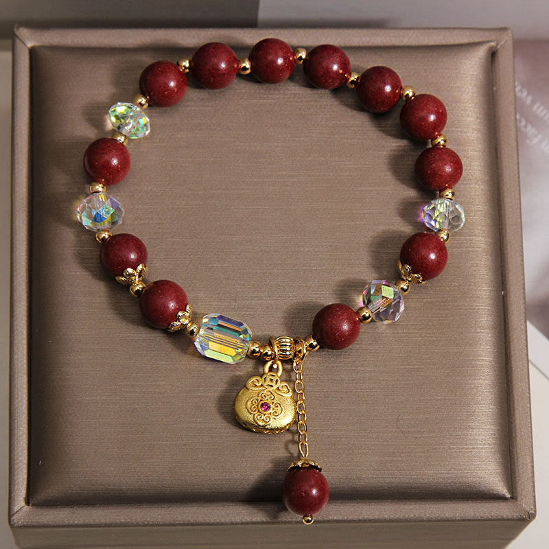 Armband Sandelholz Glück Heilung rote Perlen Kristalle goldener Anhänger Schmuckbox
