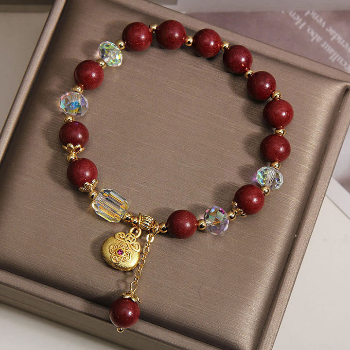 Armband Sandelholz Glück Heilung rote Perlen Kristalle goldener Anhänger Geschenkbox