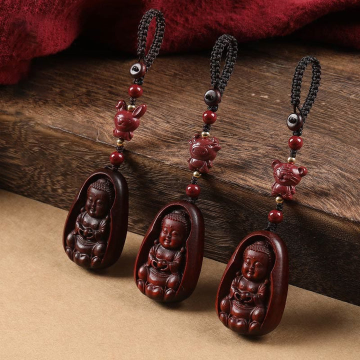 Schlüsselanhänger Buddha Sandelholz Tierkreis geschnitzt rotes Holz spirituell Glücksbringer