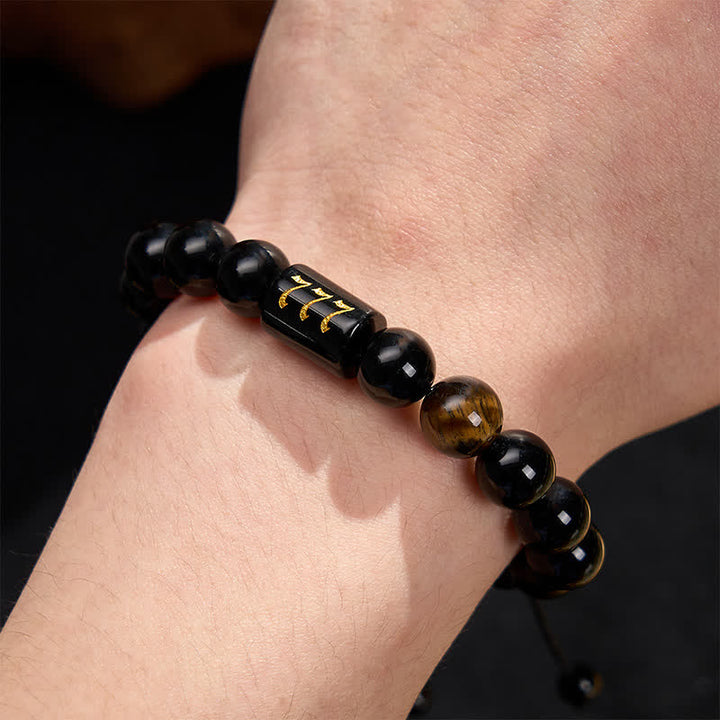 Armband Schwarzer Obsidian Tigerauge Stärke Segen am Handgelenk getragen