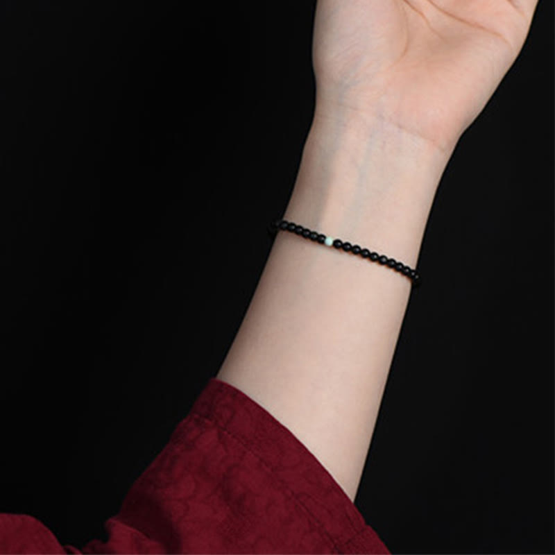 Armband Schwarzer Obsidian Türkis – Stärke am Handgelenk getragen feines Perlenarmband
