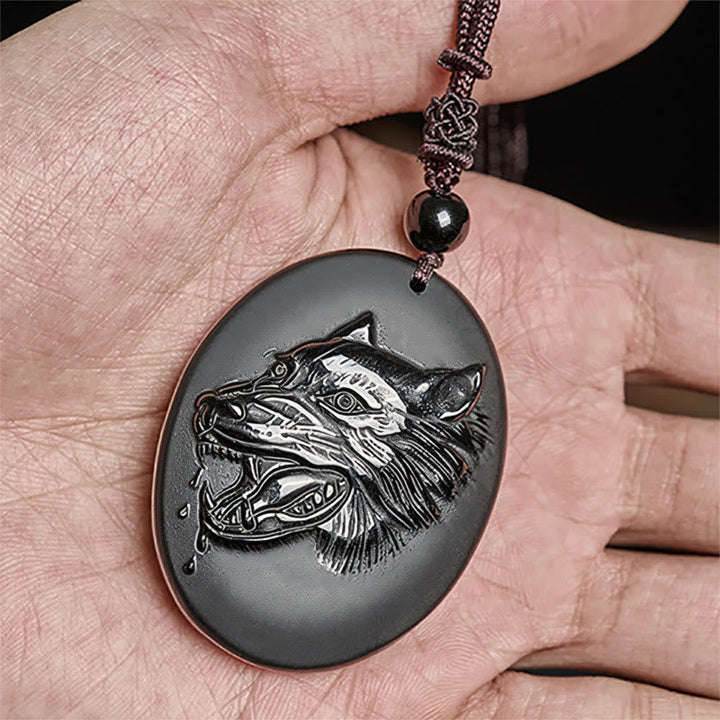 Schwarzer Obsidian Wolfanhänger an Kette in der Hand Stärke