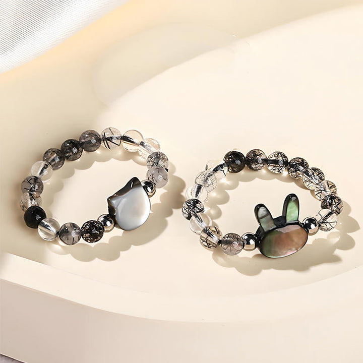 Zwei Rutilquarz Ringe mit Tridacna Hasen Katze Anhänger Design
