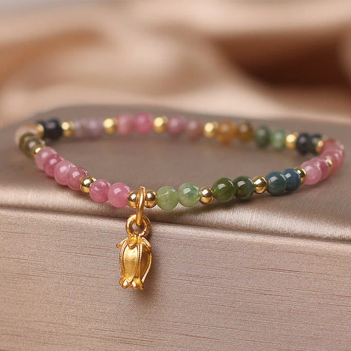 Armband Turmalin Blüten – Energie mit rosa grünen Perlen Golddetails