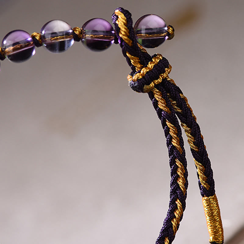 Armband Amethyst Zinnober Balance Glück geflochten Kordel violett goldene Perlen Detail