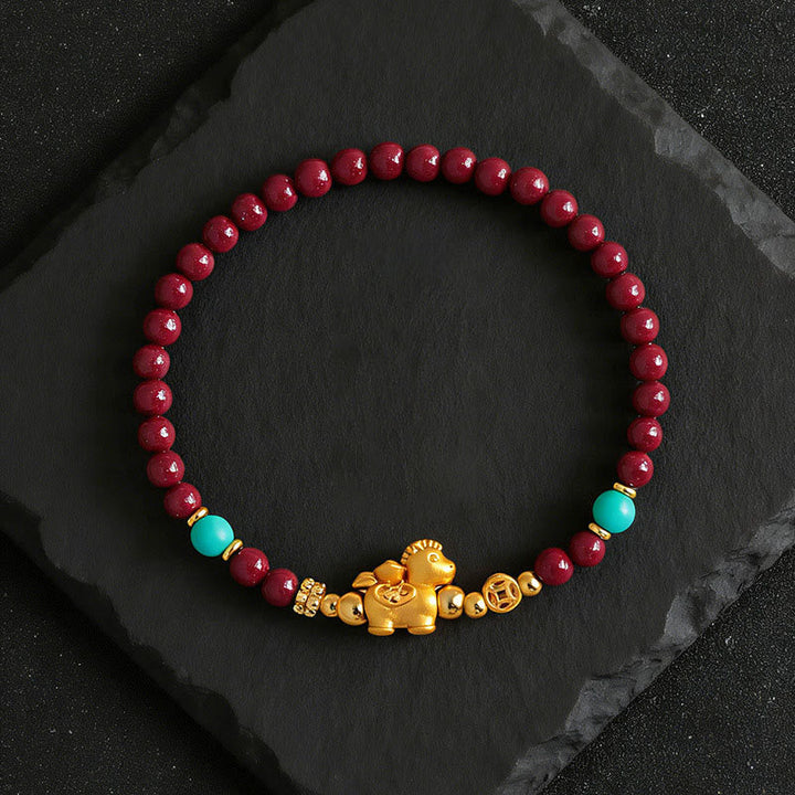 Armband Zinnober Fu-Zeichen Ruhe Energie rote Perlen goldenes Pferd Türkis