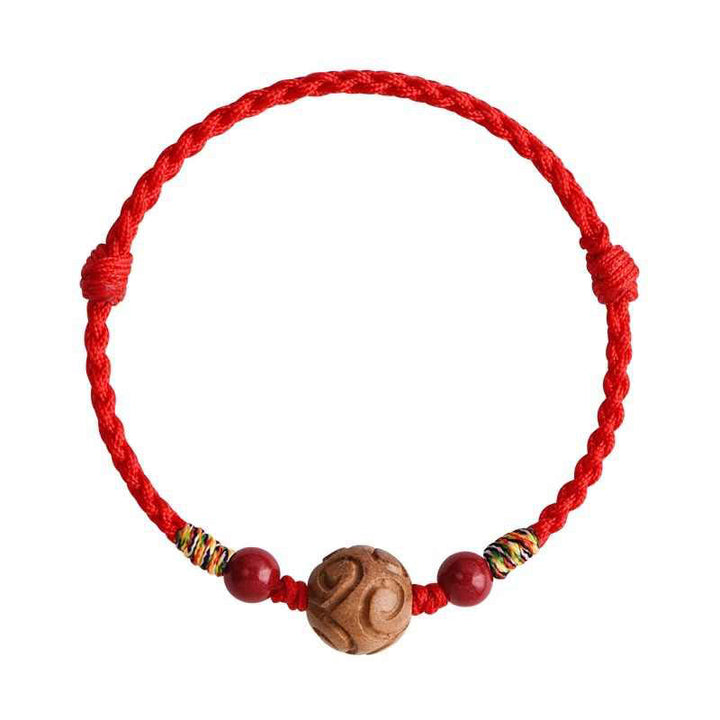 Armband Pfirsichholz Zinnober Glück rote Kordel geschnitzte Perle Handgelenk