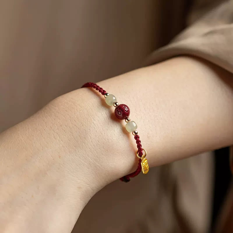 Armband Zinnober Jade Om Mani Padme Hum Wohlstand getragen Handgelenk rot